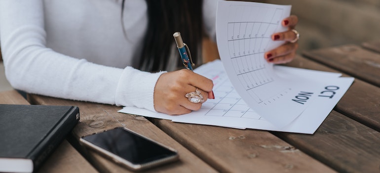 Woman marking days on a calendar.