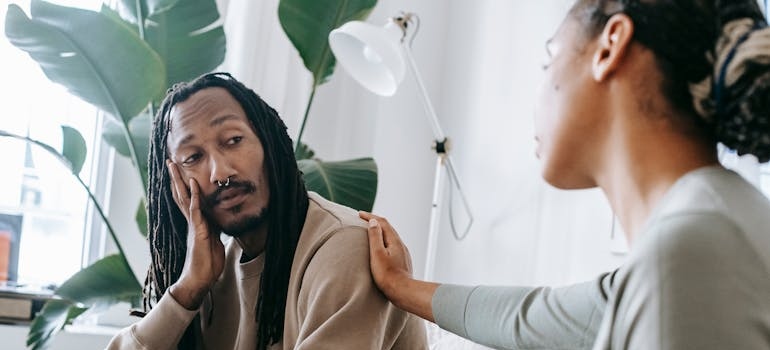 Therapist supporting a client during a therapy session.